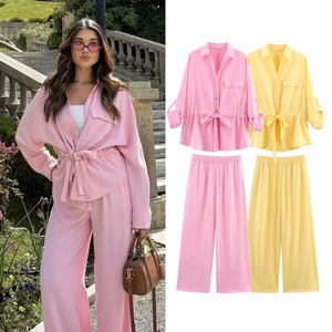 Detail view of women's long sleeve drawstring shirt and wide-leg pant set in pink and yellow