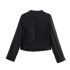 Detailed back view of black tweed jacket featuring textured weave and elegant fringe edges