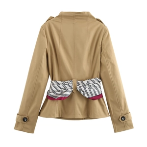 Detail of khaki cropped trench coat featuring a chic striped scarf belt tied in a bow
