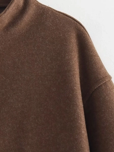 Detail of high collar and drop shoulder seam on a brown wool blend jacket for women