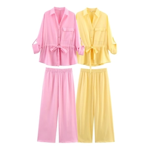 Detail of drawstring long-sleeve shirt and wide-leg pants set in pink and yellow hues