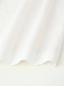 Close-up of high-quality white cotton linen fabric showing breathable texture and weave