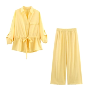 Detail of pale yellow drawstring waist shirt and matching wide-leg pants set