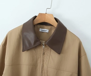 Detail of khaki windbreaker with contrast dark brown faux leather collar and zipper closure