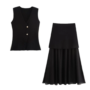 Detail of V-neck vest with gold buttons and pleated skirt ensemble in black