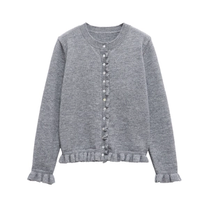 Détail du cardigan gris en maille avec bordures à volants et boutonnage simple sur le devant