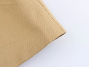 Detailed close-up showing precision stitching and khaki twill fabric texture of the jacket