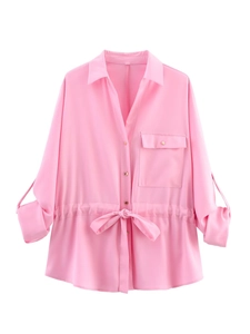 Detail of pink long-sleeve shirt with drawstring waist, chest pocket and gold buttons