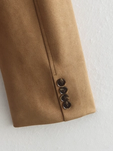 Detail of sleeve cuff on tan suede blazer featuring four dark tortoiseshell buttons