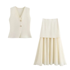 Detail of cream white knit vest with gold buttons and matching pleated skirt set