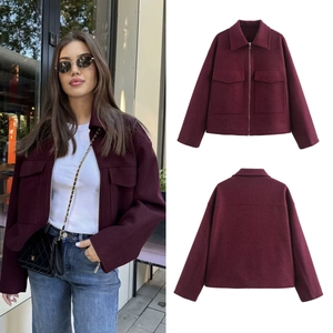 Detail view of burgundy zip-up wool jacket with large utility pockets and classic collar