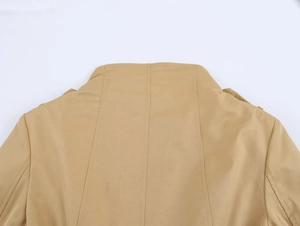 Close-up of the back neckline and tailored stitching on this khaki double-breasted trench coat
