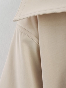 Detail of premium twill fabric texture and stitching on trench coat collar and shoulder