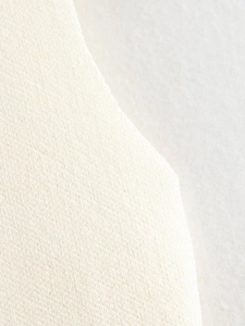Close-up of cream knit fabric showing soft texture and premium stitching details