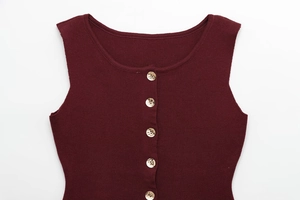 Detailed view of the dark red ribbed knit vest featuring elegant gold accent buttons