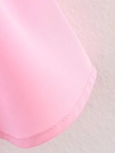 Macro detail of pink drawstring shirt hem featuring clean single-needle stitching texture
