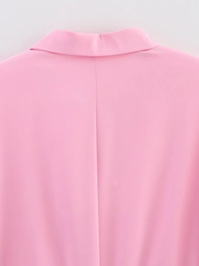 Detail of pink blouse back seam and high-quality fabric texture for a sleek office look