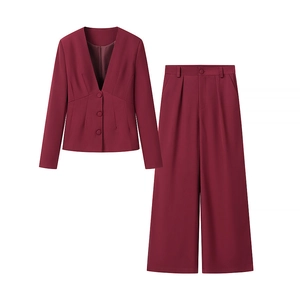 Detail of burgundy deep V-neck blazer with matching high-waisted wide-leg trousers