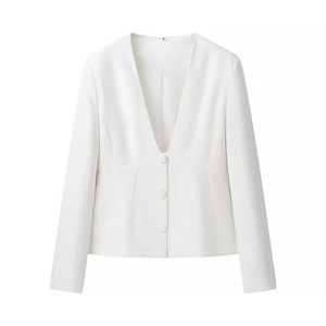 Detail view of the deep V-neck and fabric-covered buttons on this white tailored blazer