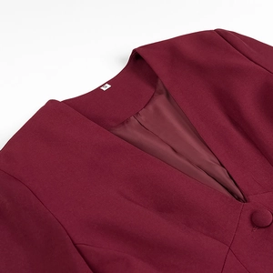 Close-up of V-neckline and fabric texture on a wine red blazer with size S tag