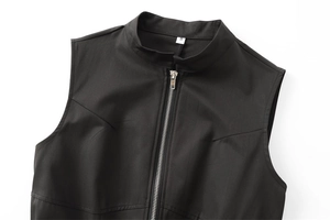 Detail of black sleeveless top featuring high collar, metal zipper, and size S label