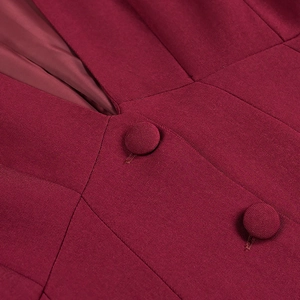 Detailed macro view of burgundy blazer with twill texture and matching fabric buttons