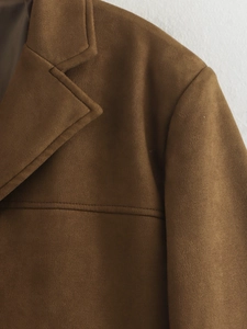 Detail showing high-quality brown suede texture and stitching on the lapel of this jacket