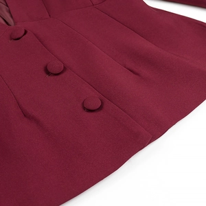 Detail of burgundy blazer featuring covered buttons and high-quality woven fabric texture