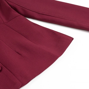 Close-up of high-quality twill stitching on burgundy blazer sleeve and side seams