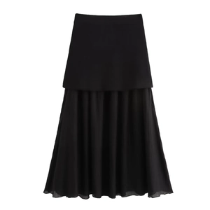 Detail view of black double-layered midi skirt with pleated chiffon hemline and smooth top