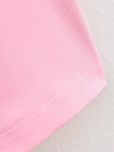 Detail view of pink twill fabric texture and precise single-needle stitching finish