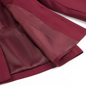 Detailed close-up of burgundy blazer interior showing silk lining and stitching