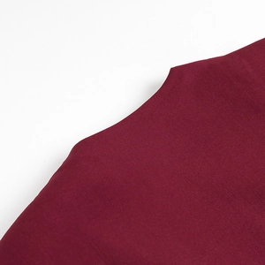 Detail shot of wine red plain weave fabric showing smooth texture and high-quality fibers