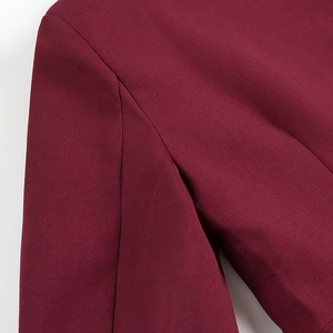 Close-up of wine red blazer shoulder seam showing high-quality twill fabric texture