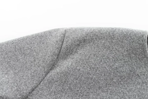 Detailed close-up of premium gray wool-like fabric texture on a fashion bomber jacket