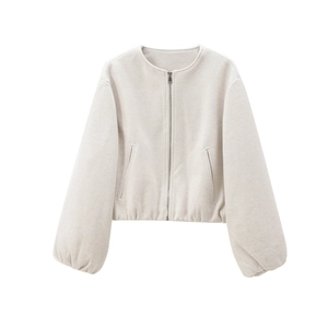 Detail of beige bomber jacket featuring a round neck, metal zipper, and balloon sleeves
