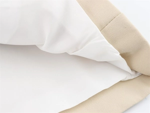 Close-up of khaki twill fabric stitching and smooth white lining on casual short trench coat