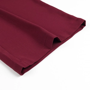 Detail of burgundy pants leg opening featuring twill fabric texture and neat stitching
