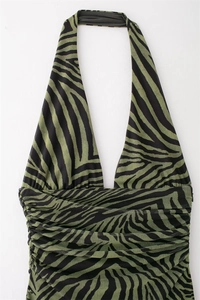 Detail of green zebra print mesh dress featuring a halter deep V-neck and ruched texture