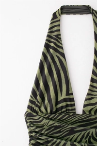Detail of green zebra print mesh halter top featuring intricate ruching and soft texture