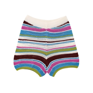 Detailed view of colorful striped crochet knit shorts with elastic waistband and boho texture