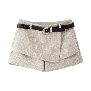 Dettaglio dello skort in tweed con cintura a cerchio dorato e trama in tessuto fine