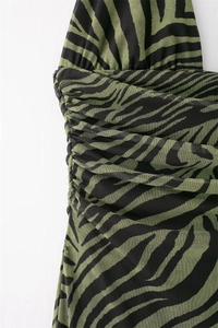 Detail of green zebra print mesh dress featuring ruched texture and a halter neck design