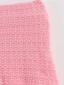Vue macro détaillée de la texture du tissu en maille gaufrée rose pour femmes