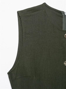 Detail view of olive green linen sleeveless top showing seam stitching and button accents
