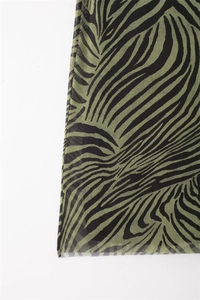 Close-up of olive green and black zebra print on lightweight sheer mesh fabric dress