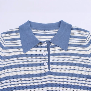 Détail du polo en tricot à rayures bleues et blanches avec texture ajourée et boutons