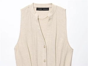 Detailed close-up of oatmeal beige sleeveless V-neck top with fabric texture and buttons