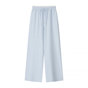 Detail of high-waist blue striped pants with white lace trim and drawstring waist