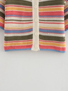 Close-up of multicolored crochet polo knit cardigan with horizontal stripes and buttons